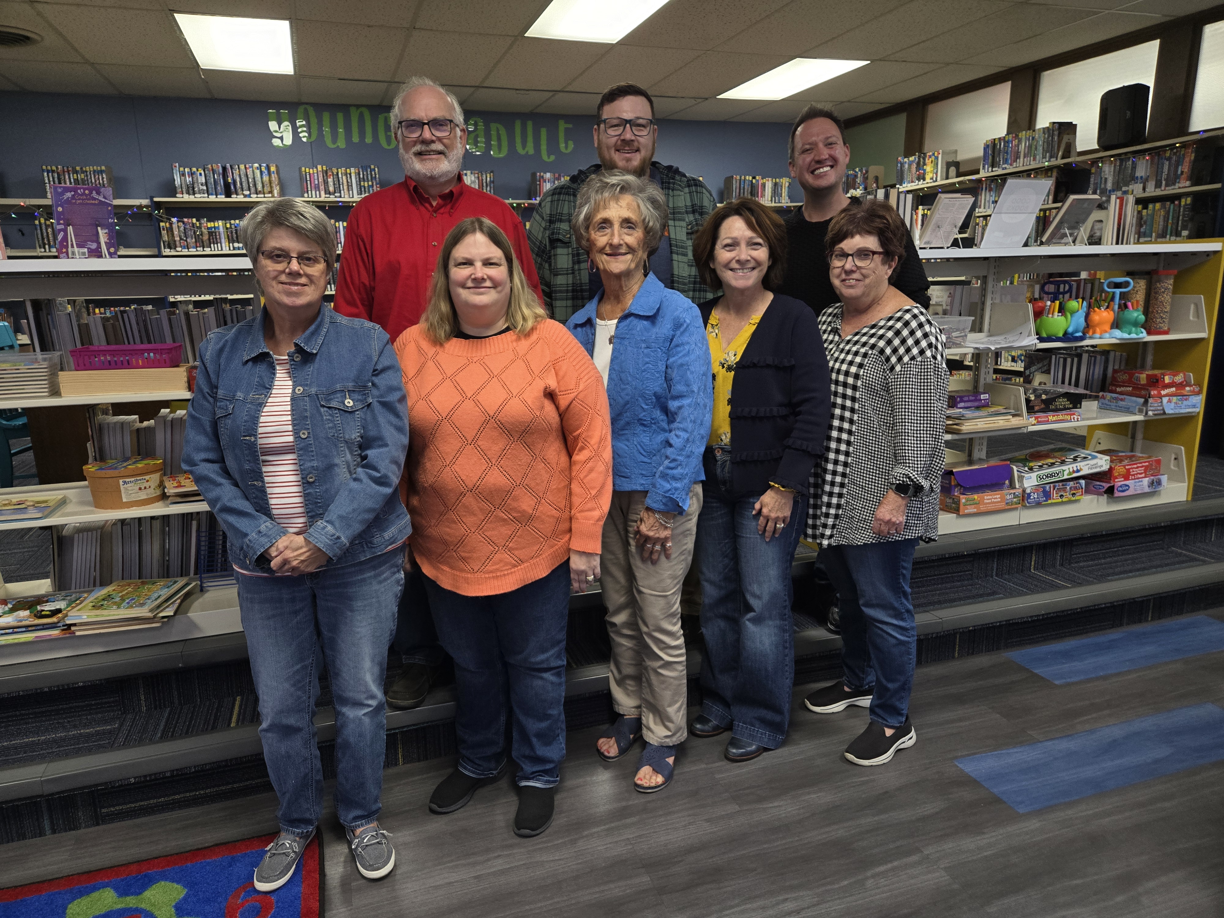 Photo of current board members standing in front of library shelves